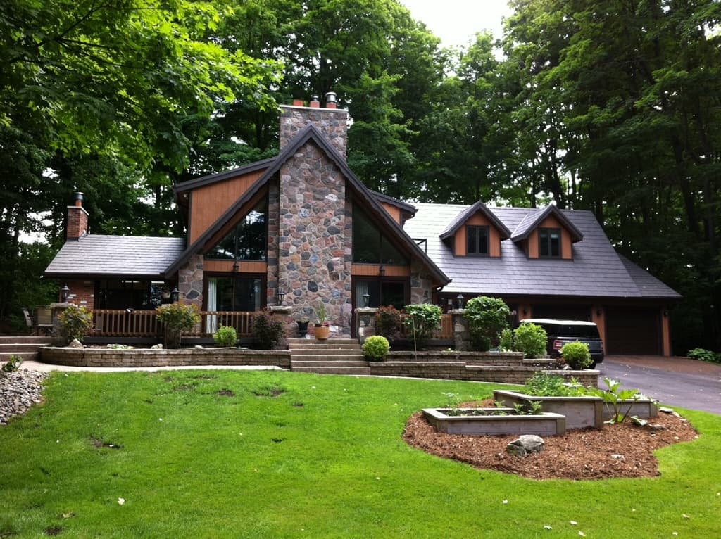 Stone-front cottage on a wooded lot