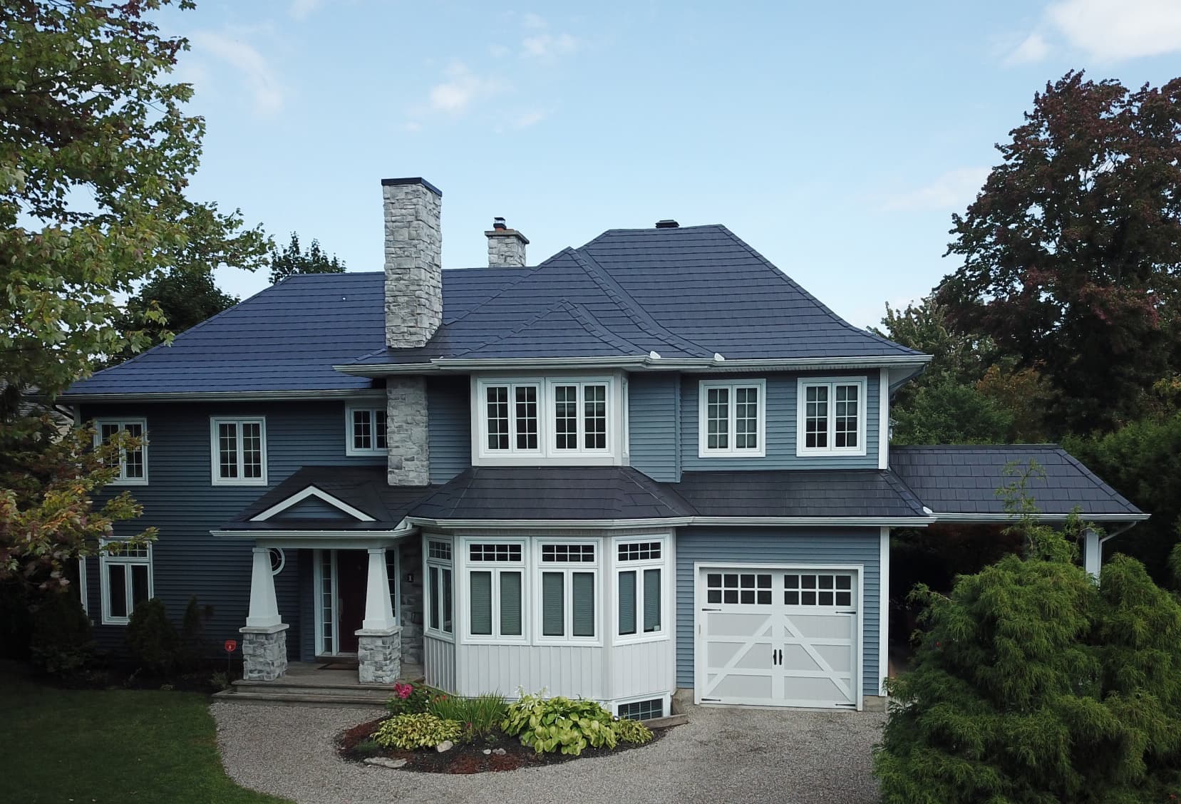 Wakefield Bridge in Black Mica installed on a navy-clad two-storey home