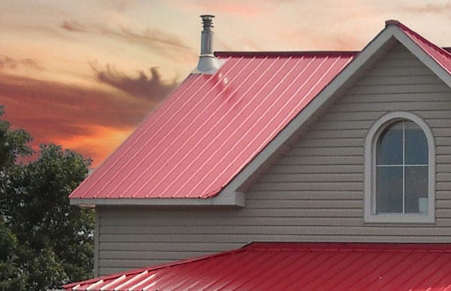 Ameri-Cana corrugated steel roofing panel installed on a country home at sunset