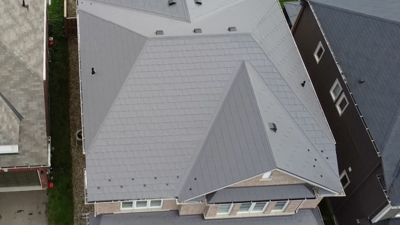 Granite Grey Wakefield Bridge steel shingle roof in Angus, Essa Township — drone frame of the finished install