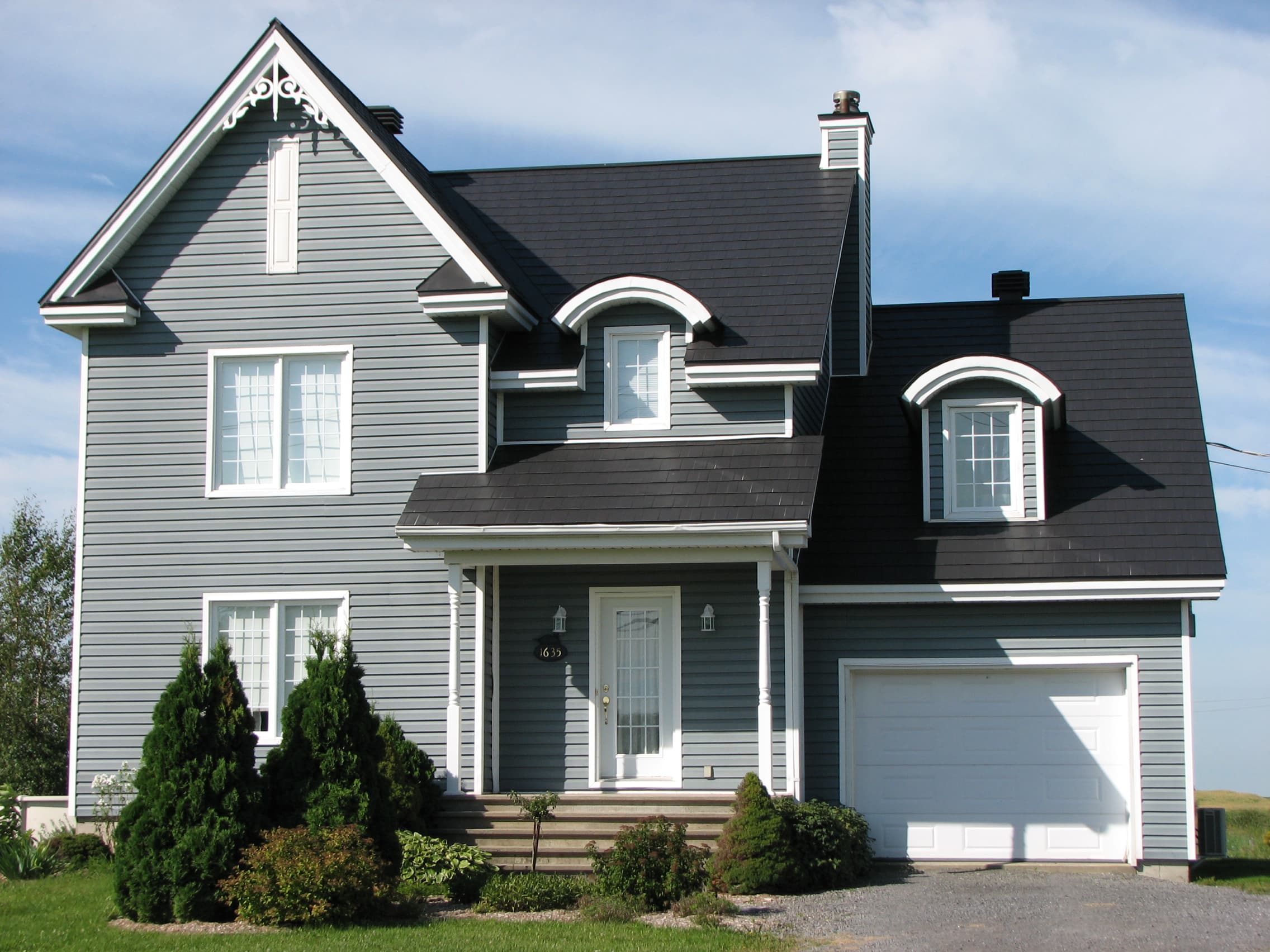 Metal shingle roof on a two-storey home with dormers